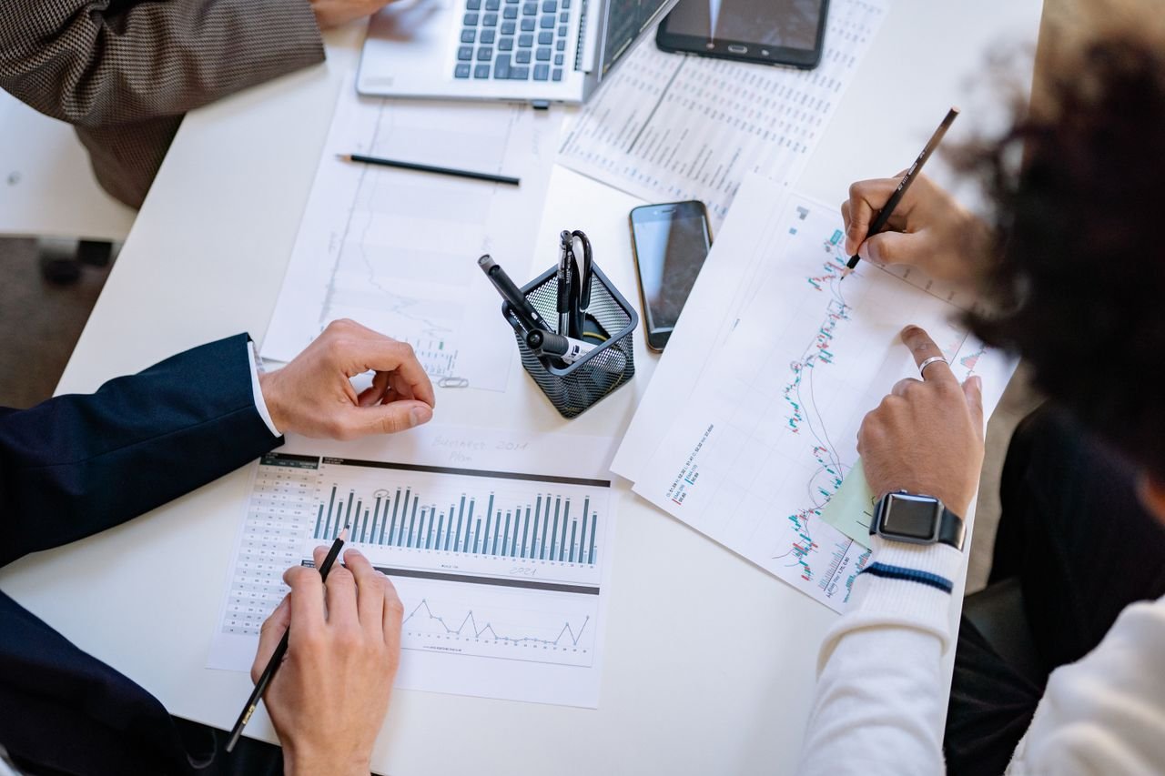 The Art of Drawing Readers In: Your attractive post title goes here Business team analyzing financial charts and graphs during a collaborative meeting.